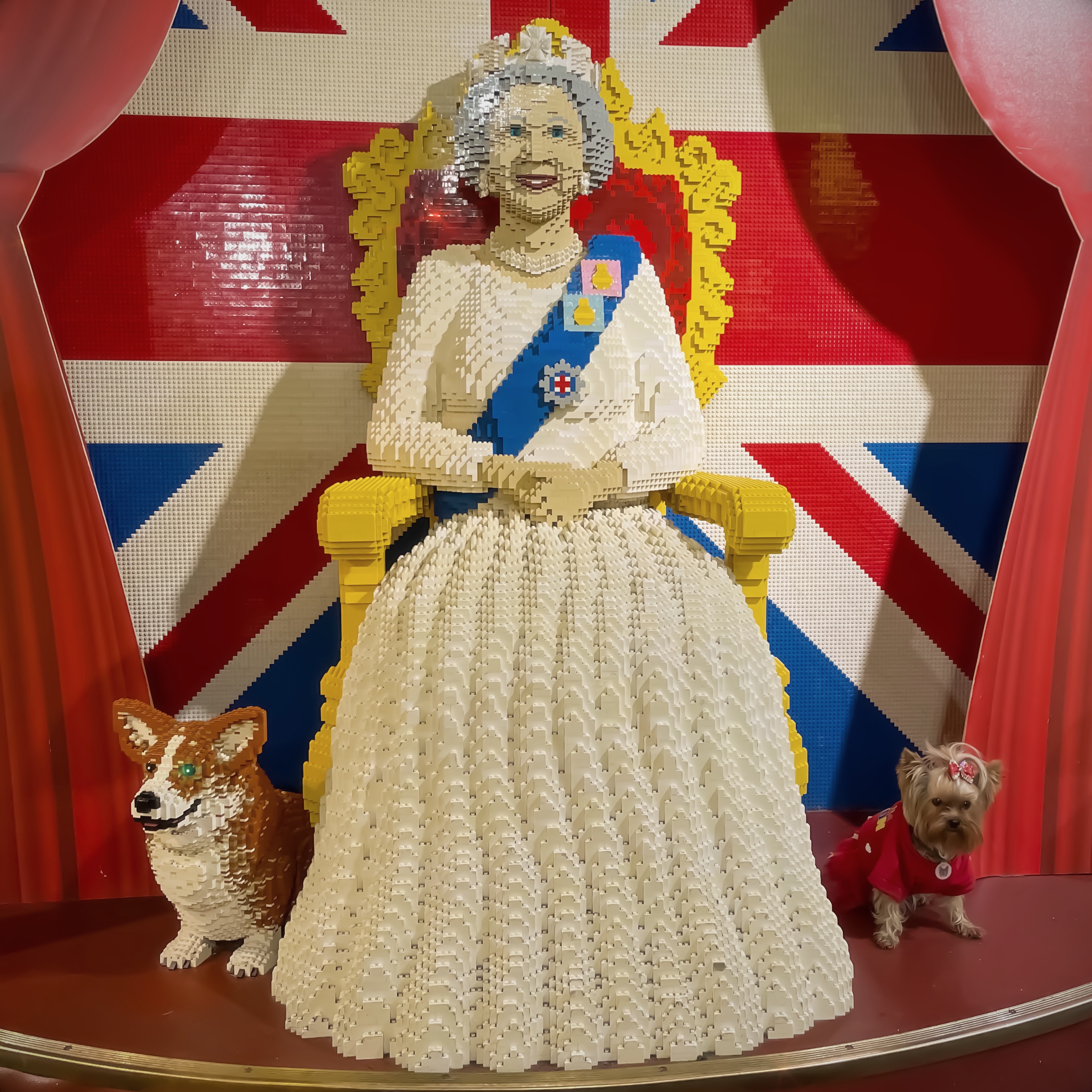 Esme beside a LEGO sculpture of Queen Elizabeth II
